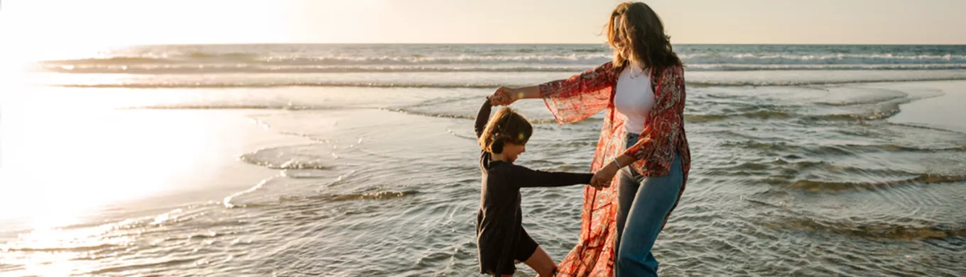 Mother and child playing on the beach 