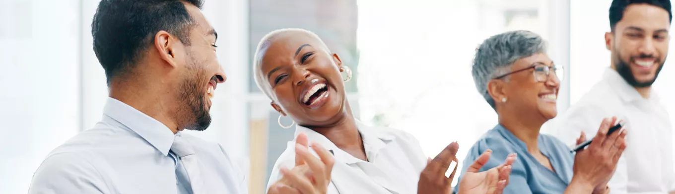 Group of happy employees clapping