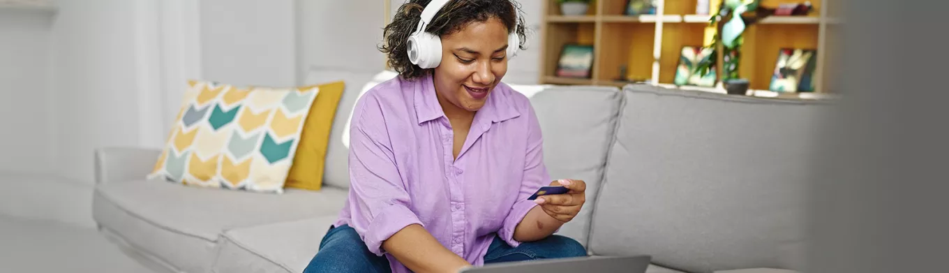 woman wearing headphones and shopping online 