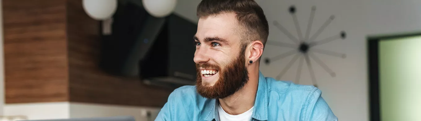 Happy man sitting at his desk 