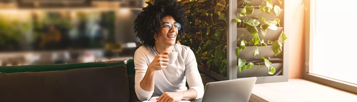 Woman sitting at home working on laptop 