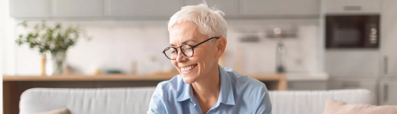 Happy older lady saving some money 