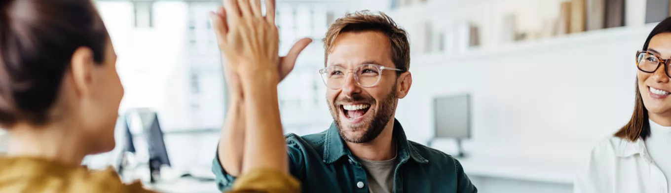 Happy employees giving each other a high five 