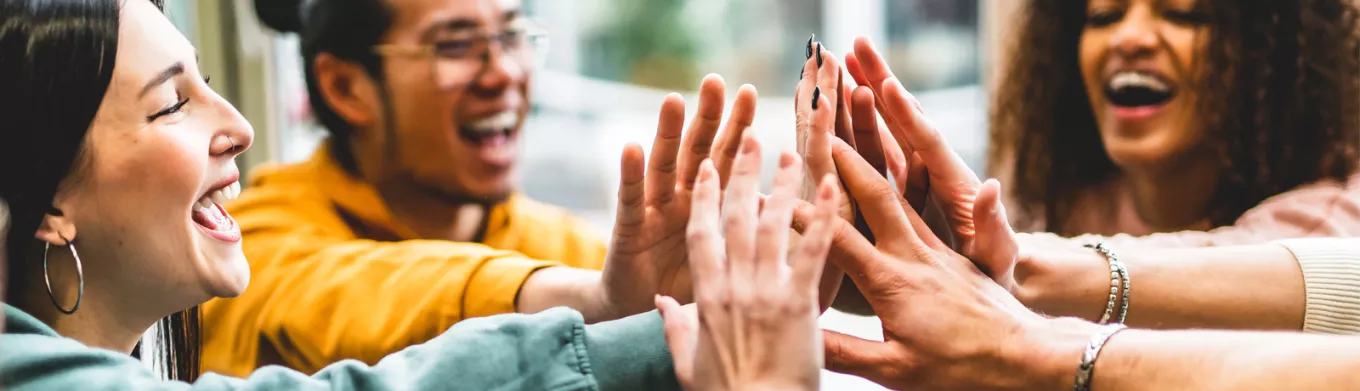 Group of people giving each other a high five 