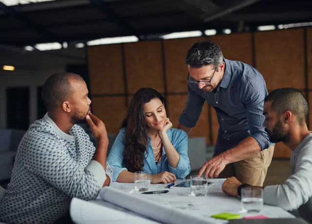 group of people looking at plans 