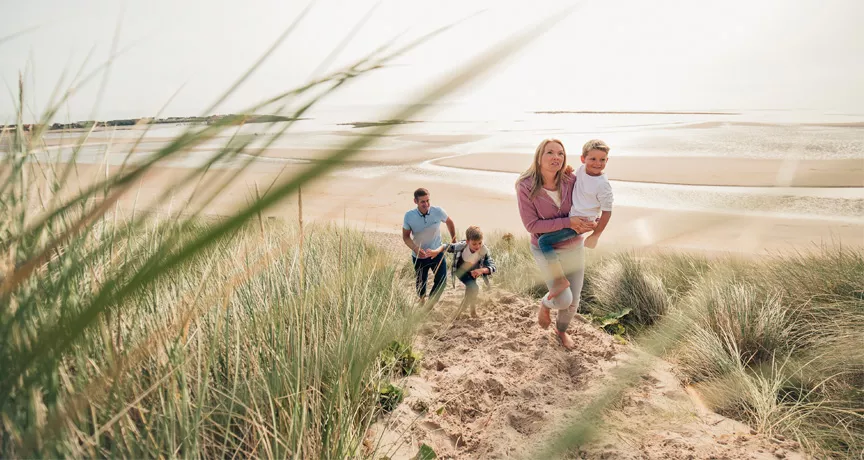 Family strolling along a beach 