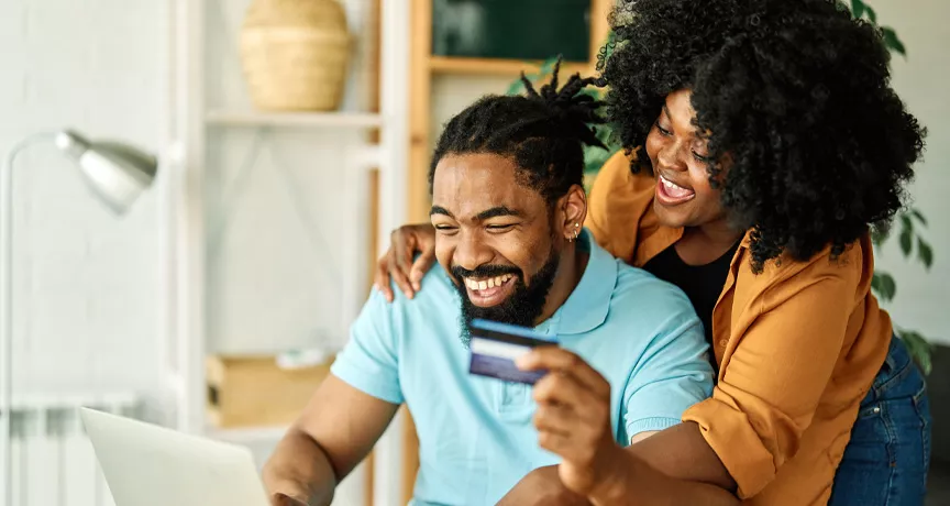 man and woman online shopping with payment card