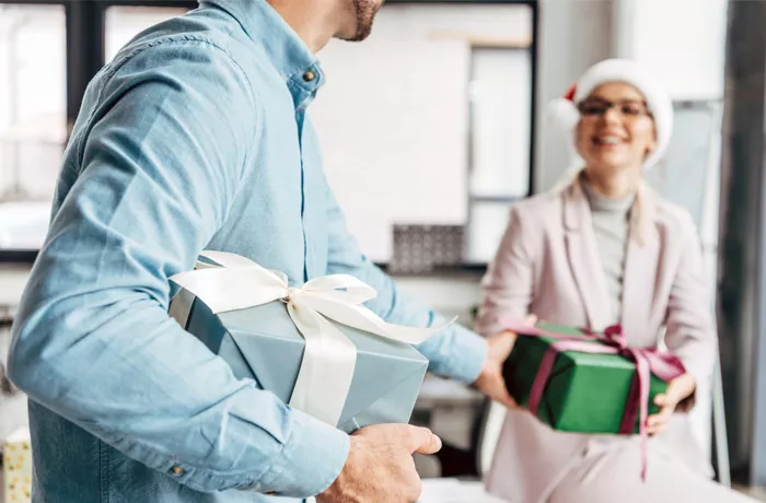 Colleagues giving each other a gift