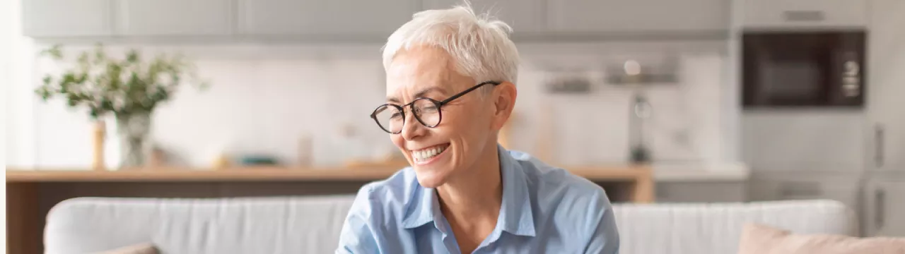 Happy older lady saving some money