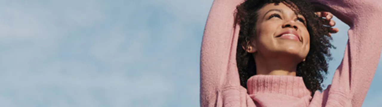 lady in pink against a blue sky