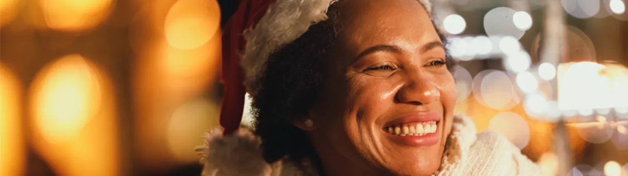 lady smiling in her Christmas hat