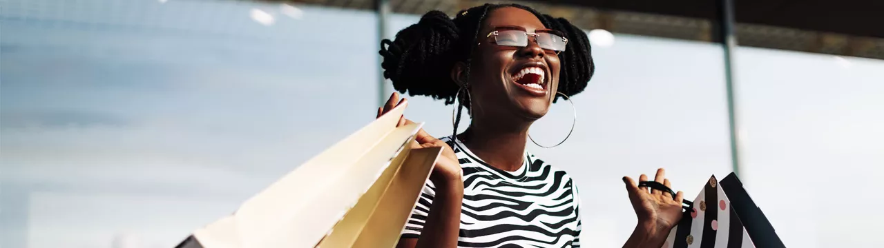girl with lots of shopping looking very happy