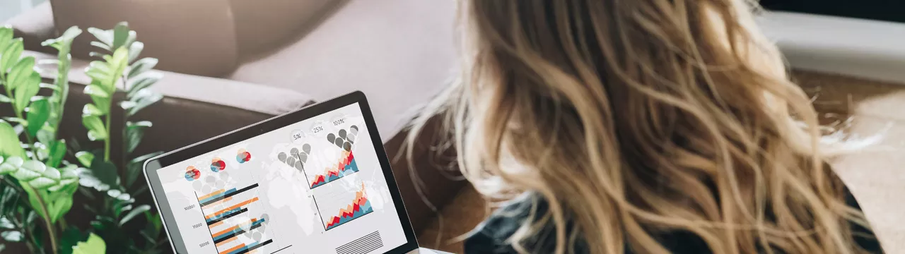 woman reviewing reports on laptop