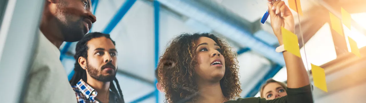 Group of colleagues brainstorming with sticky notes