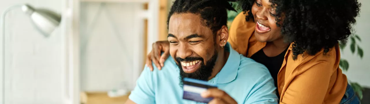 man and woman online shopping with payment card