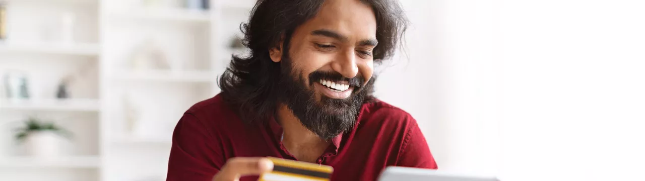 man using his card to pay online