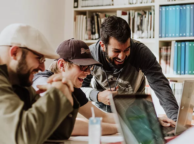 Making Saving Simple - Three men laughing and collaborating at work 