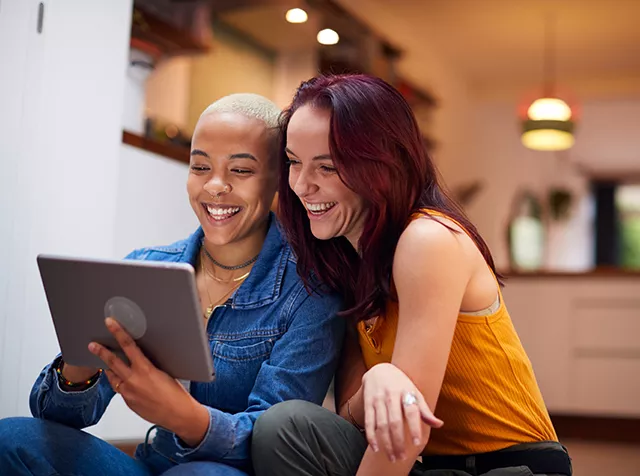 Two happy women with a tablet