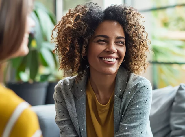 lady with afro sitting with some people