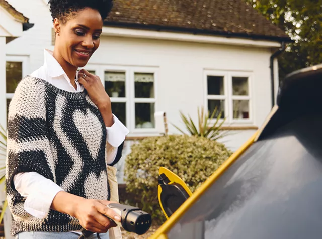 woman charging her electric car