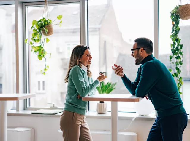man and woman having a coffee at work