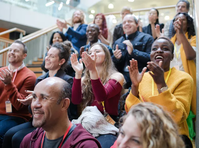 Group of people applauding