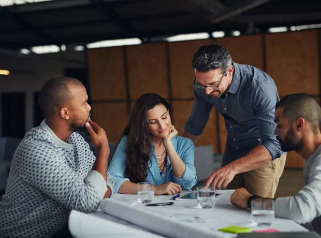 group of people looking at plans