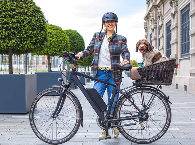 woman with her bike and dog