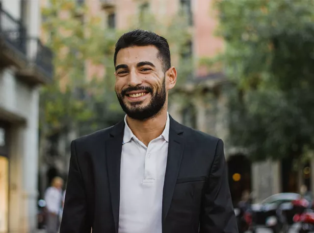 man standing in the street smiling