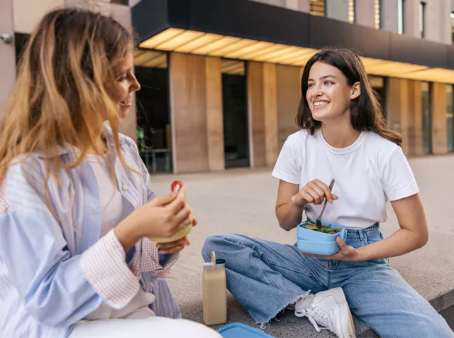 two female colleagues having lunch outside