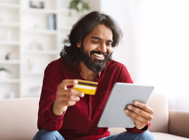 Asian man paying for something with bank card