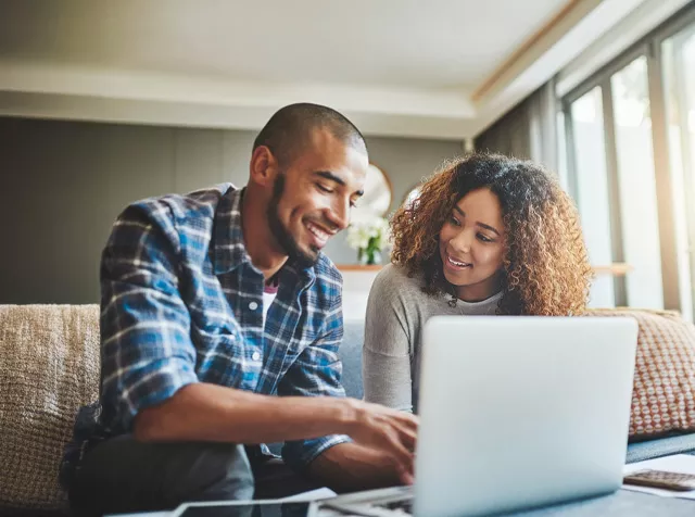 man and woman working over laptop