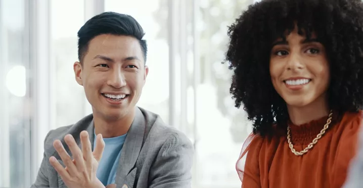Male and female colleagues looking happy