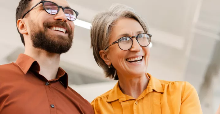 Older man and woman looking smart and smiling