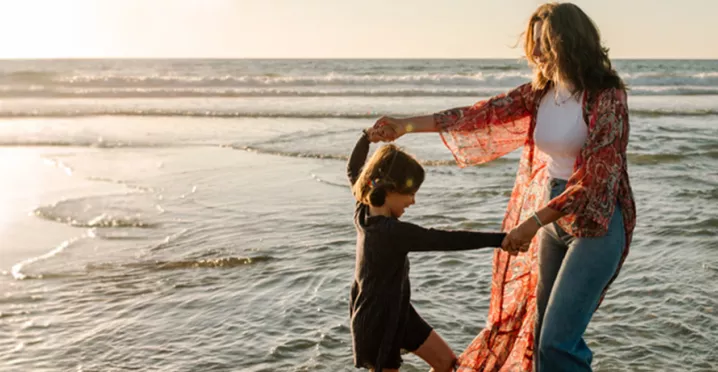 Mother and child playing on the beach