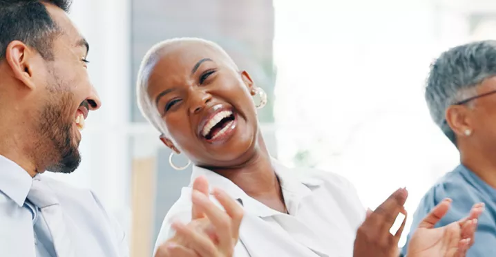 Group of happy employees clapping