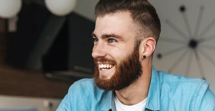 Happy man sitting at his desk