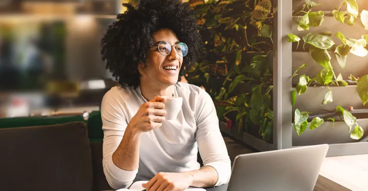 Woman sitting at home working on laptop