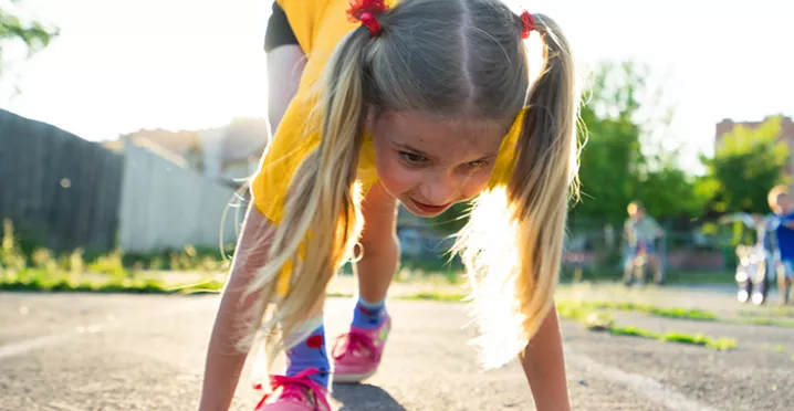 Young girl about to start a running race