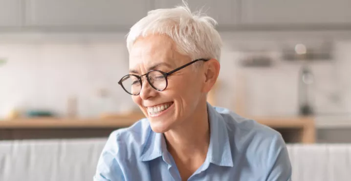 Happy older lady saving some money