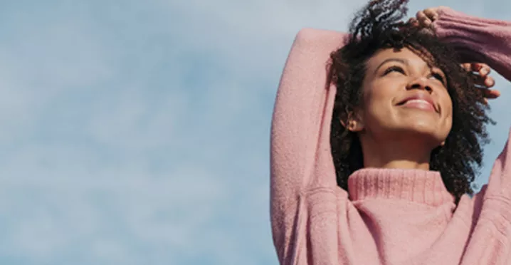 lady in pink against a blue sky