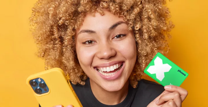 lady smiling and holding her Pluxee Card
