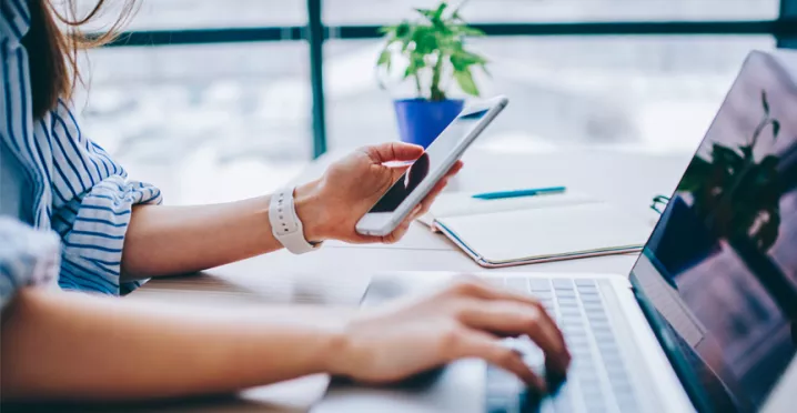 blog upload - woman on phone and laptop
