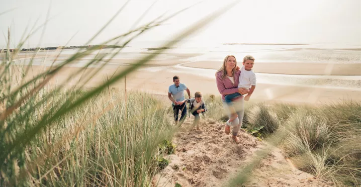 Family strolling along a beach