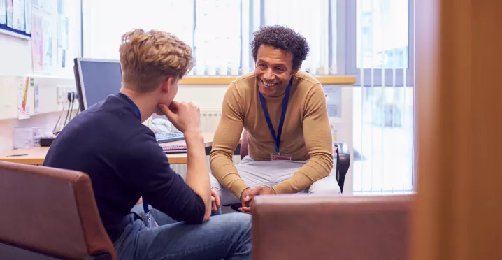 student and teacher having a conversation