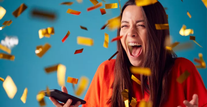 woman celebrating with gold confetti everywhere