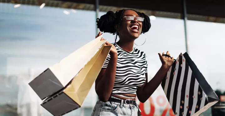 black lady very happy with her shopping bags