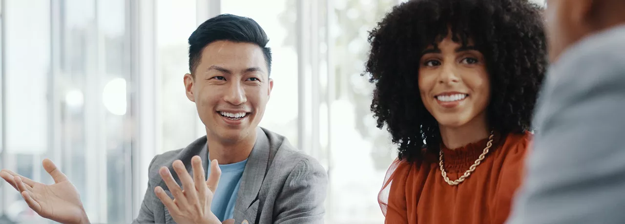 Male and female colleagues looking happy
