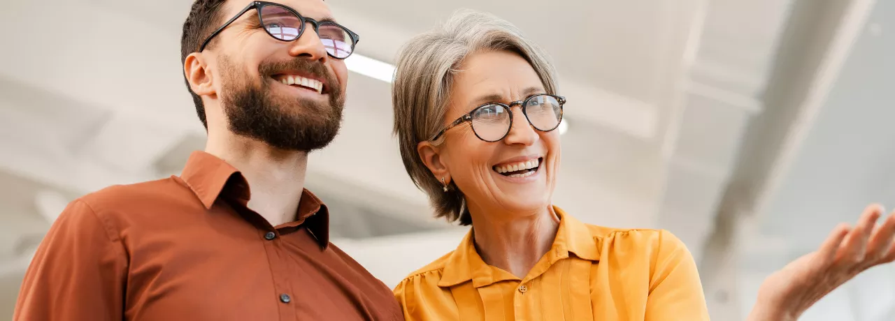 Older man and woman looking smart and smiling