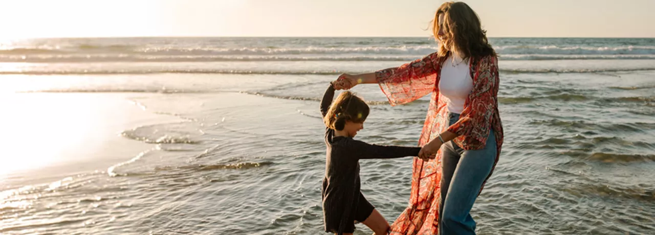 Mother and child playing on the beach
